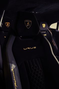 the interior of a sports car with black and gold trims