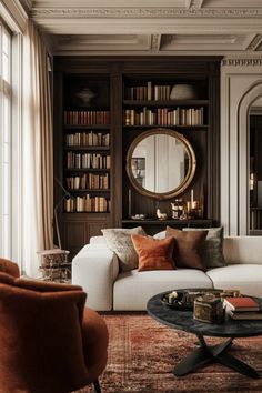 a living room filled with furniture and bookshelves