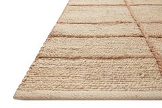 a beige rug with some lines on the top and bottom, as well as an area rug