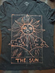 a black shirt with an image of the sun on it