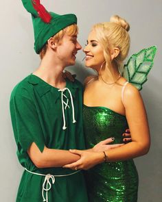 two people dressed up as tinkerbells and one is wearing a green dress