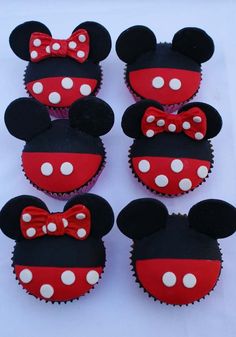 mickey mouse cupcakes are decorated with red and white polka dots, ears and bows