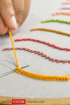 someone is stitching something on a piece of fabric