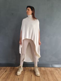 This super comfortable poncho features high neck collar and asymmetric length.  ✥ SHIPPING Express shipping: 2-3 biz days via DHL Worldwide ✥ SIZING The model in the picture wears size M. Height: 5'9" and weigh 60 kg. Available sizes: XS - 3XL Please, refer to my Size Chart below to find your perfect size match! Keep in mind that each height can be adjusted to yours!  I'll be happy to make the item per your body measurements - just leave your height, bust, waist, and hips in "NOTE TO SELLER " se Oversized White Cape Poncho, Oversized White Poncho Cape, Poncho Winter, Poncho Women, White Poncho, Winter Poncho, Turtleneck Poncho, Knit Poncho, Ladies Poncho