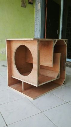 a wooden box sitting on top of a white tile floor