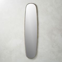 an oval mirror mounted on the wall