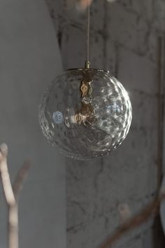 a clear glass ball hanging from a ceiling