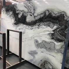 white and black marble is being displayed in a storeroom with metal racks on the floor