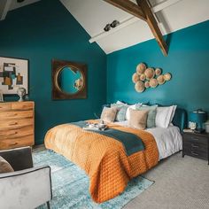 a bed room with a neatly made bed and blue walls