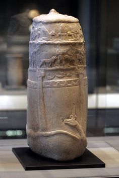 a large white vase sitting on top of a table