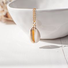 "Lovely gold plated cowrie shell necklace. This seashell necklace is made from a gold plated shell pendant and a gold plated stainless steel chain. Measurements & Details: * The shell is about 0.9\" (23mm), the chain is available in various lengths 16\"- 30\" (41-76cm). * This seashell necklace comes in a gift box - perfect for gift giving and safekeeping. * Buying this cowrie necklace as a gift? Add a handwritten card with a message of your choice. ➳ Want to see more gold plated necklaces? Plea Sea Shell Jewellery, Cowrie Necklace, Shell Jewellery, Cowrie Shell Necklace, Gold Heart Locket, Seashell Pendants, Necklace Stand, Mermaid Gifts, Seashell Jewelry