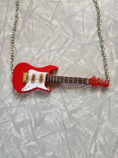 Red Guitar Necklace. 🎸This is for 1 Necklace. The chain on each side of the Guitar is 8 inches long. It has a 3 inch extender on it. 🎸 This is such a cool little realistic Guitar. The Guitar itself is 5 inches long. If you love Music, Statement or wild jewelry, then this necklace is for you.  If you have any questions please feel free to contact me.  Thank you for shopping at my store. Have a Totally Awesome Day!😎 Red Electric Guitar, Totally Awesome, Thank You, Guitar, Jewelry Necklace Pendant, Jewelry Necklaces, Things To Come, Pendant Necklace, Accessory Gift