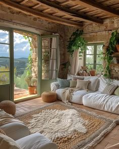 a living room filled with lots of furniture next to a stone wall covered in greenery