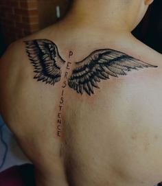 the back of a man's chest with an angel wing tattoo on his left side