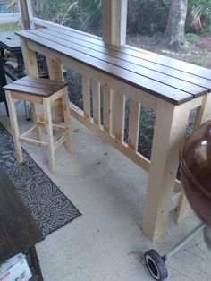 two wooden stools sitting next to each other in front of a window