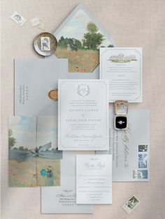 the wedding stationery is laid out on top of each other, including an envelope