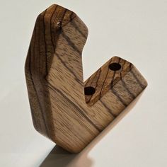 a wooden object that looks like it has been carved into the shape of a letter