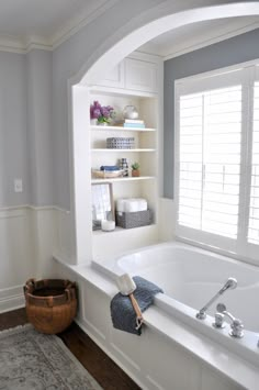 a white bath tub sitting next to a window