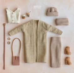 a doll's clothes and accessories are laid out on a white surface with a pink background