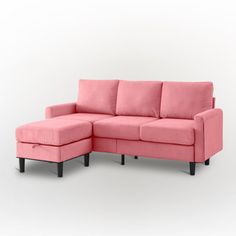 a pink sectional couch sitting on top of a white floor