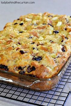 a casserole dish on a cooling rack with blueberries and apples in it