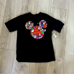 Disney, Walt Disney World Parks, Happy Halloween T-Shirt, New With Tags, Black T-Shirt With Adorable Mickey Ears With Happy Halloween And A Graphic Print On The Front, On The Side Is Walt Disney World And Embroidery, Size Medium Black Disney T-shirt For Disney Trips, Disney Halloween Graphic Print T-shirt, Graphic Print T-shirt For Disney Fan Events In Fall, Black Themed T-shirt For Disney Fan Events, Themed Black T-shirt For Disney Fan Events, Disney Halloween T-shirt, Black Themed T-shirt For Disney Trips, Black Disney T-shirt For Fall, Disney Halloween Short Sleeve Tops