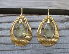 "A bohemian chic inspired handcrafted masterpiece in solid 18k Gold Large Hoop Earrings accented with Lemon Quartz. The earrings are hand carved giving way to a beautiful intricate texture, further accented with Lemon Quartz makes a timeless classic jewel. (e-124) Lemon Quartz(6.85cts) 11.5mm x 16.5mm Gold weight 15grams Drop length 2.5\" *Follow us @belesasjewelry on Instagram for promotions/giveaways *LIKE* us on Facebook http://www.facebook.com/Belesas *If you like the ring, please click on t Elegant Gold Faceted Hoop Earrings, Artisan Gold Teardrop Hoop Earrings, Gold Elegant Hoop Earrings With Gemstone Accents, Elegant Gold Hoop Earrings With Gemstone Accents, Luxury Gold Faceted Earrings, Bohemian Teardrop Yellow Gold Earrings, Bohemian Yellow Gold Teardrop Earrings, Gold Faceted Teardrop Hoop Earrings, Handmade Teardrop Yellow Gold Hoop Earrings