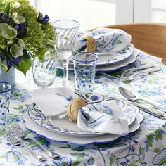 the table is set with blue and white dishes