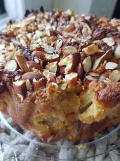 a cake with nuts on top in a glass dish