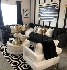 a black and white living room with gold accents on the walls, couches and rugs