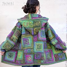 a woman is wearing a colorful crocheted coat