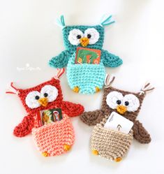 three crocheted owls sitting next to each other on top of a white surface