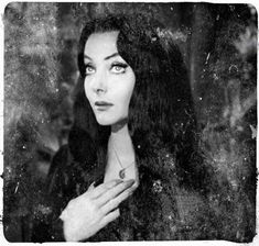 black and white photograph of a woman with long hair wearing a ring on her finger