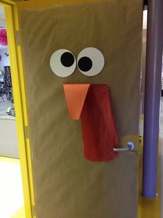 a brown paper bag with eyes and nose sticking out of it's side door