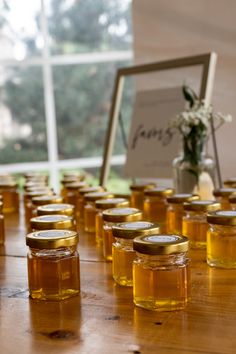 honey jars are lined up on a table