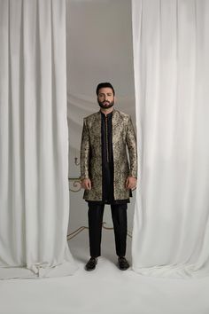 Upgrade your style with our Black and Gold Prince Coat. Made from luxurious brocade material, this front open coat exudes royalty. Paired with an Indian raw silk kurta pajama, it's the perfect ensemble for any formal event. Elevate your look and make a statement with this unique and elegant piece. 3-Piece Suit Elegant Raw Silk Sherwani With Traditional Drape, Elegant Raw Silk Sherwani Straight Kurta, Elegant Sherwani With Zari Work Straight Kurta, Elegant Sherwani In Raw Silk With Straight Kurta, Elegant Sherwani With Zari Work, Elegant Set With Zari Work And Front Open Shape, Elegant Festive Sets With Front Open, Elegant Front Open Festive Sets, Elegant Festive Front Open Sets