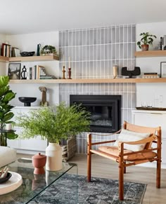 a living room filled with furniture and a fire place covered in plants next to a fireplace