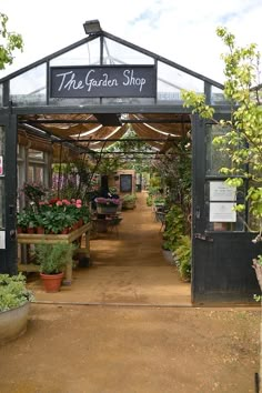 the garden shop has many potted plants in it