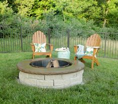 an outdoor fire pit with chairs around it