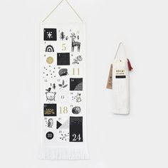 a white wall hanging next to a black and white banner with numbers on it,