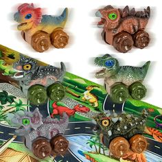 the toy dinosaurs are riding on their own train tracks, and they're all different colors