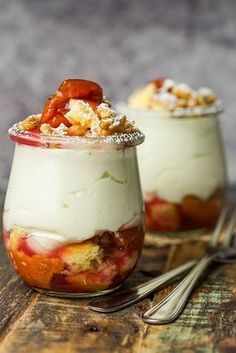 two desserts are sitting on a wooden table