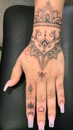 a woman's hand with tattoos on it