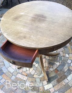 an old table has been turned into a side table with drawers on it and is sitting in the middle of a cobblestone patio