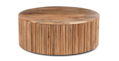 a round wooden table sitting on top of a white floor