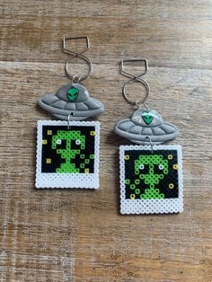 👽 Handmade alien instant picture tunnel gauge earrings! Handmade with clay, and perler beads. The UFOs  are matte finish except where the alien heads are.  Regular Earrings- 3 1/8 inches long.  Tunnel Earrings- 3 5/8 inches long. Clip On Earrings- 3 1/8 inches long.  measurements are approximate Jewelry Care: to keep your jewelry in optimal condition avoid dropping them on a hard surface as this can cause chips or fractures of the polymer clay. Keep your jewelry in a dry box or container when not in use. Avoid direct contact of perfumes, lotions or cosmetics while wearing your jewelry. Alien Ears, Tunnel Earrings, Gauge Earrings, Retro Pictures, Ear Hangers, Hanger Clips, Ear Weights, Gauged Earrings, Earrings 3