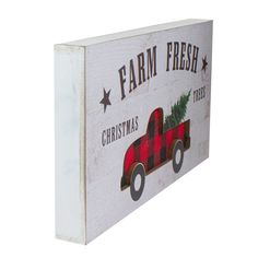 a white box with a red truck and christmas tree on the front that says farm fresh