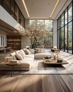 a living room filled with lots of furniture and large glass windows on the side of it