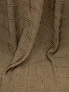 a close up view of a tan fabric with checkered design on it's edges