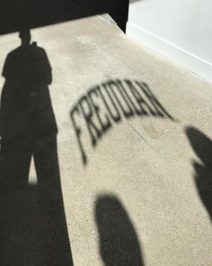 the shadow of a person standing in front of a sign that reads,'saturday '